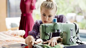 Fashion designer using sewing machine